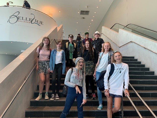 Rockingham Montessori School female students striking a photo on the staircase inside BelleVue during the Grip Leadership Student Conference