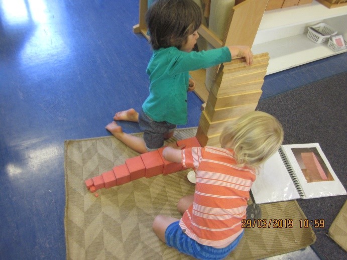Rockingham Montessori infant toddler stacking building blocks on the floor