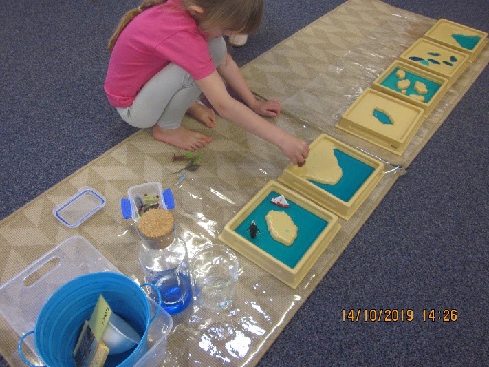Rockingham Montessori female student playing with puzzles on the floor
