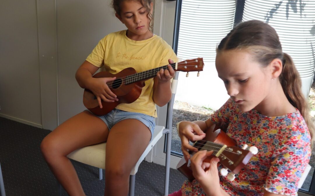 Students holding ukelele in RMS music class