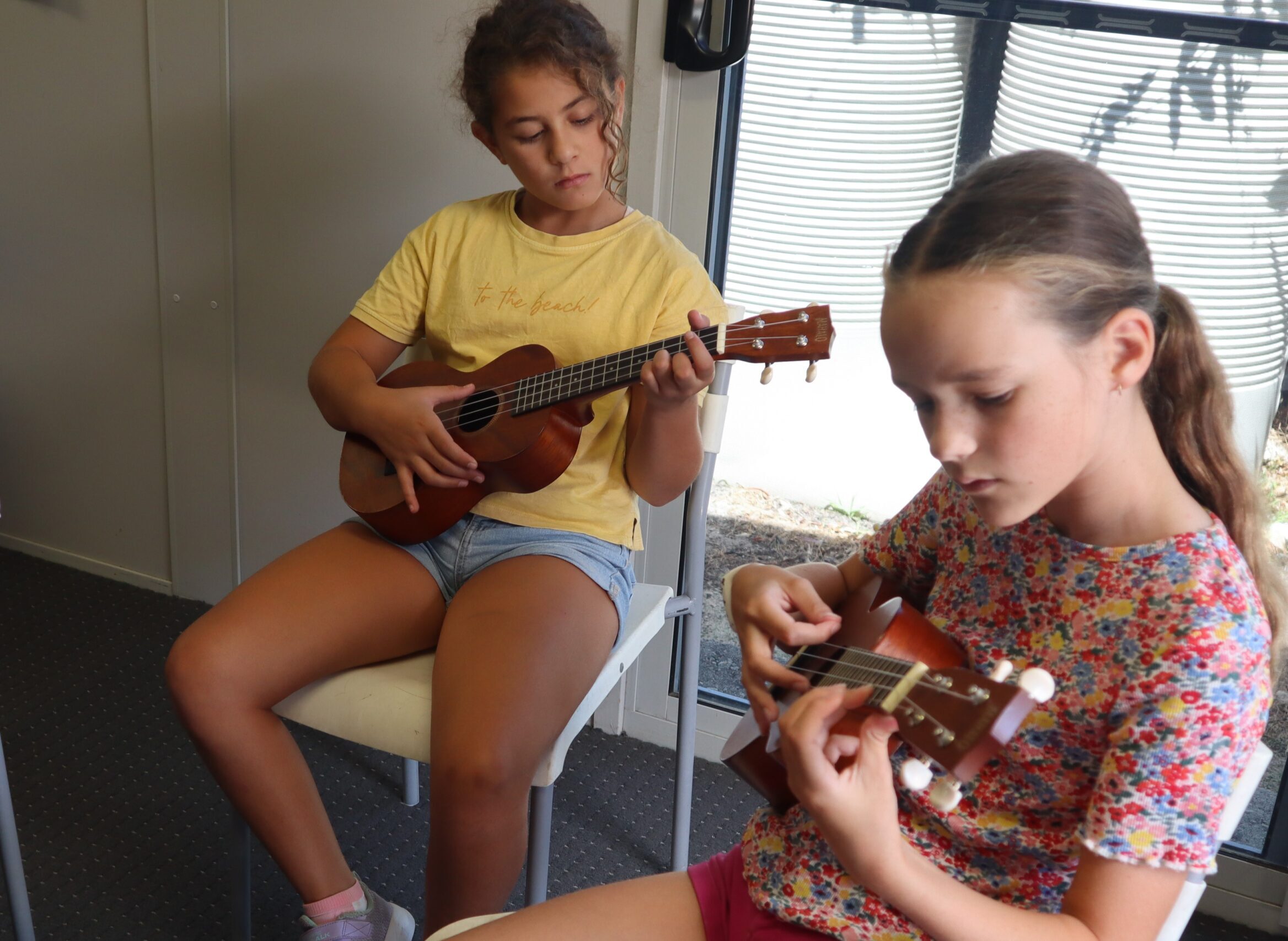 Students holding ukelele in RMS music class