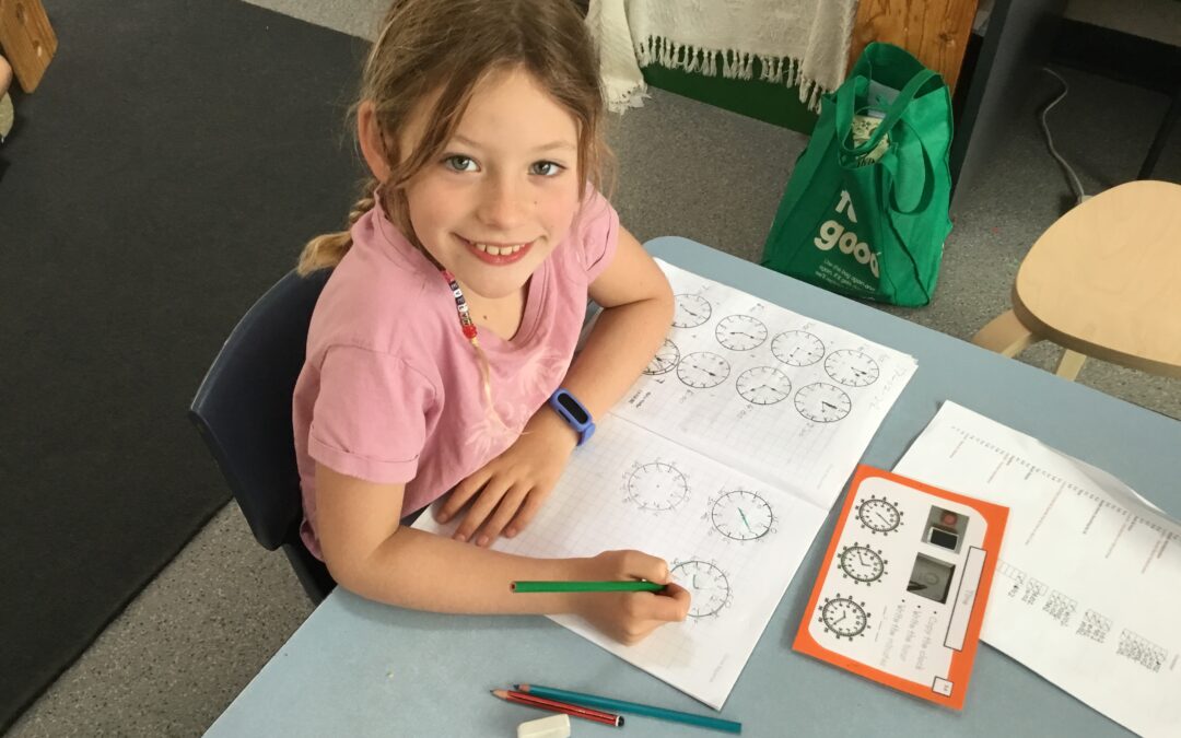 Young girl drawing clock faces at Rockingham Montessori