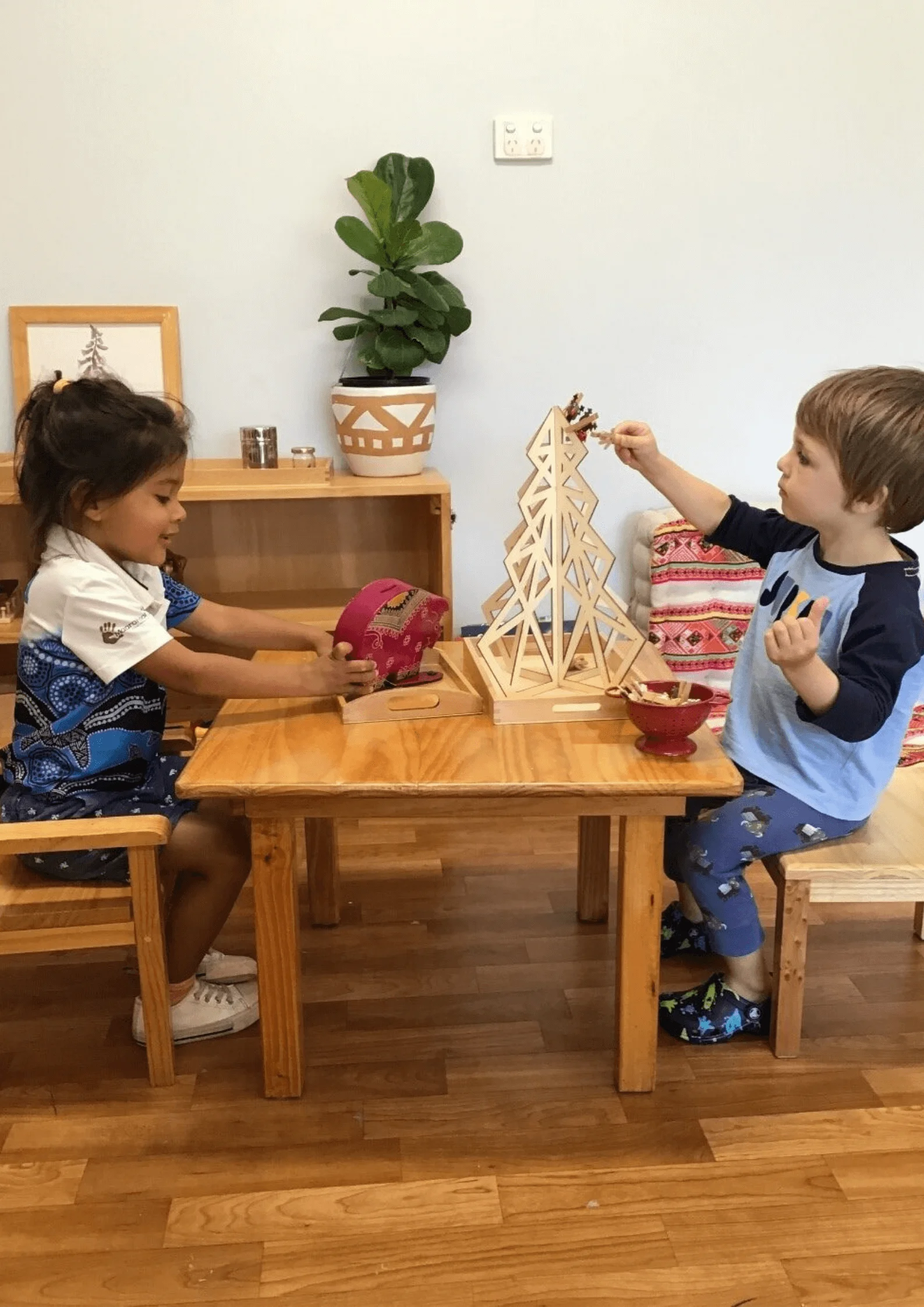 Young girl and boy at children's activity table at Rockingham Montessori